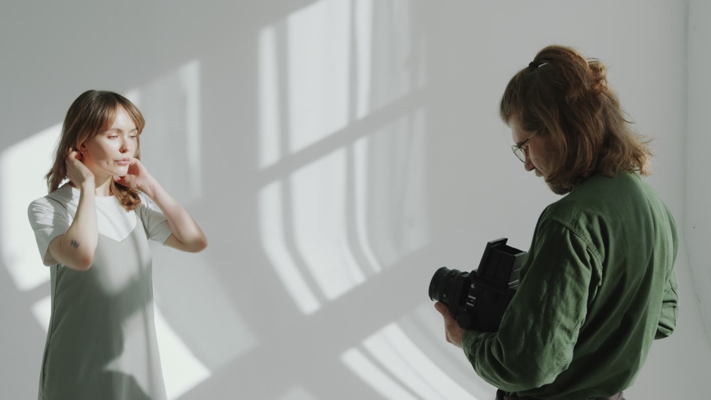 A photographer shooting a portrait in a bright studio